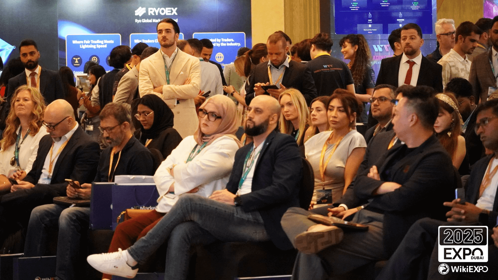Participants seated in the EXPO lobby listening to presentations